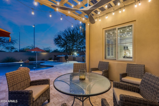 patio terrace at dusk with a fenced in pool and a pergola