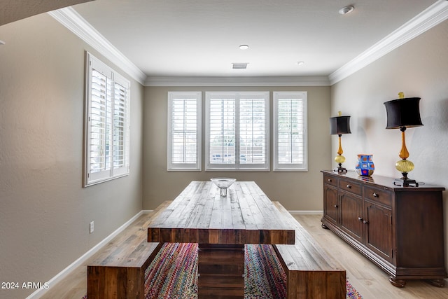 dining room with light hardwood / wood-style flooring and ornamental molding