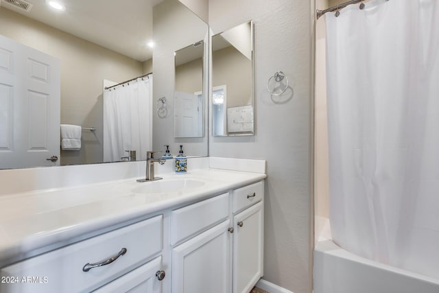 bathroom featuring shower / tub combo and vanity