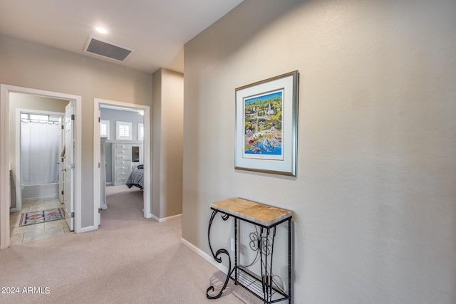 hallway featuring light carpet