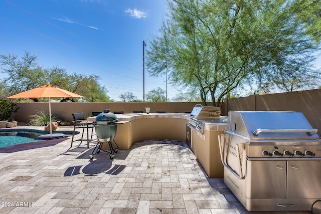 view of patio / terrace featuring area for grilling, a fenced in pool, and grilling area