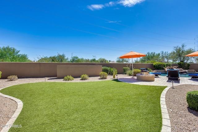 view of yard with a fenced in pool and a patio area