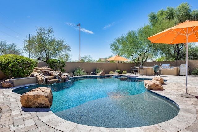 view of swimming pool with area for grilling and a patio area