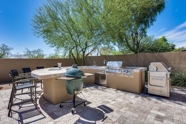 view of patio / terrace with a grill, area for grilling, and exterior bar