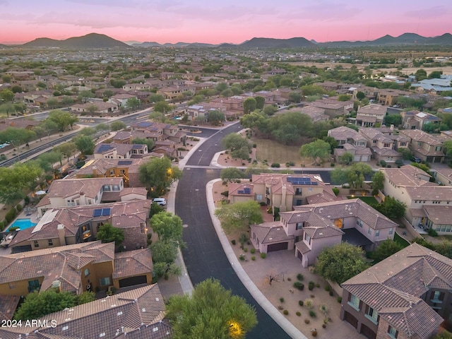 aerial view at dusk featuring a mountain view