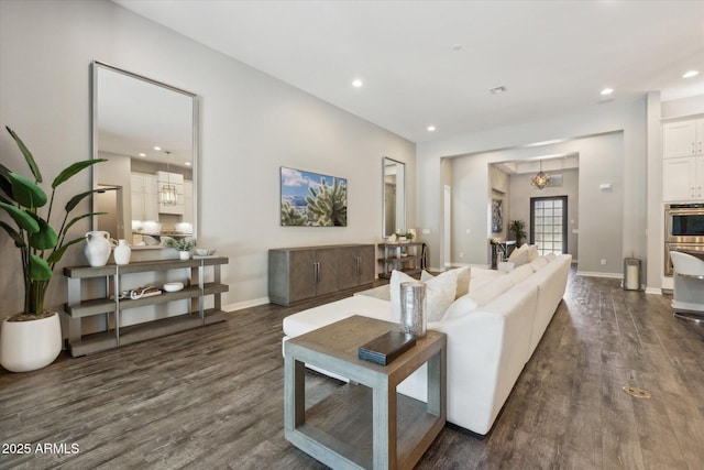 living room with recessed lighting, dark wood-style flooring, and baseboards