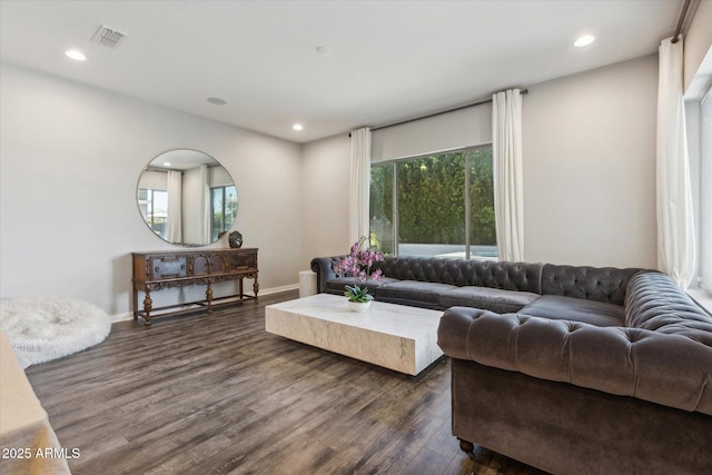 living area with visible vents, dark wood finished floors, a wealth of natural light, and recessed lighting