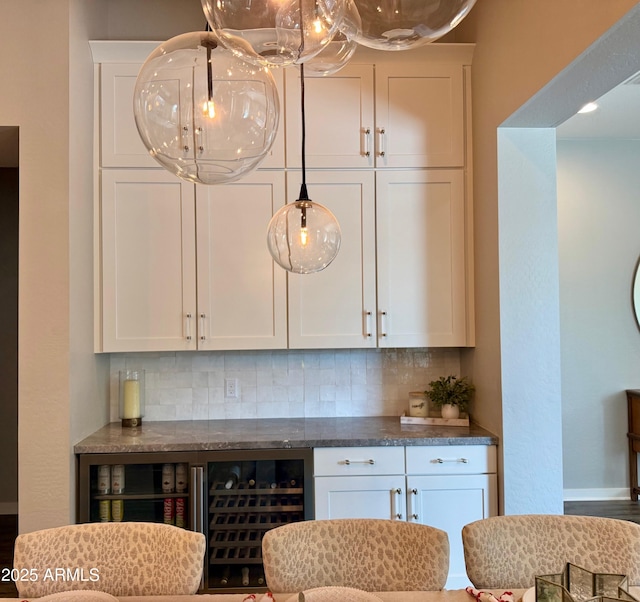 kitchen with white cabinets, beverage cooler, pendant lighting, and decorative backsplash