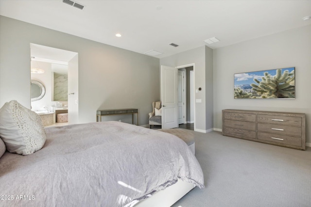 carpeted bedroom featuring baseboards, visible vents, and ensuite bathroom