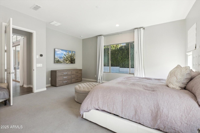 bedroom with carpet, visible vents, and baseboards