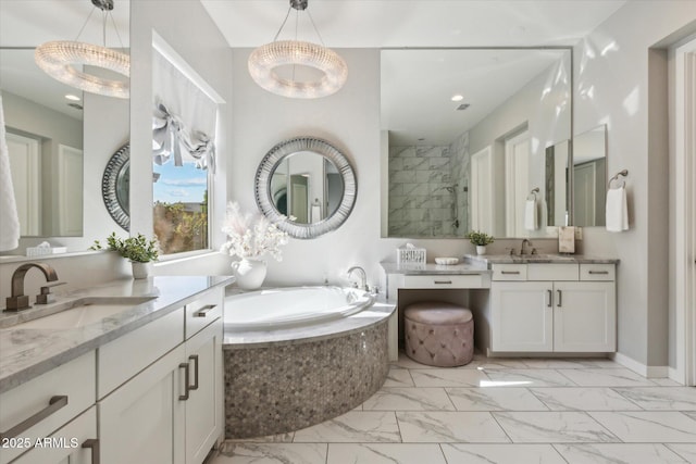 bathroom with marble finish floor, a tile shower, a garden tub, and a sink