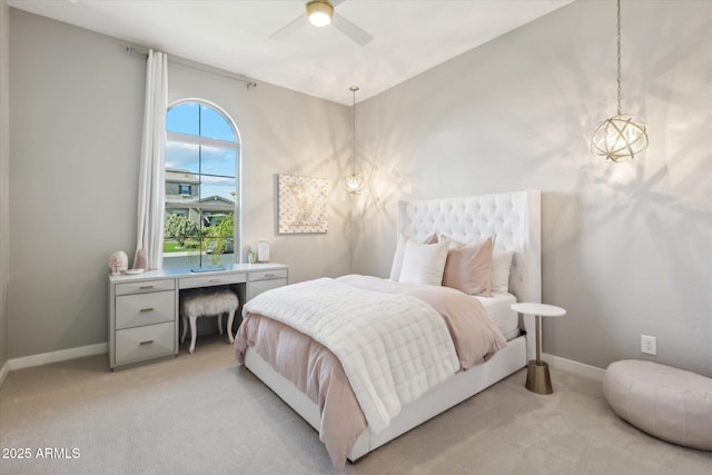 bedroom featuring light carpet, baseboards, and a ceiling fan