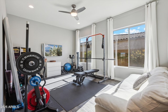 workout room featuring baseboards, a ceiling fan, wood finished floors, and recessed lighting