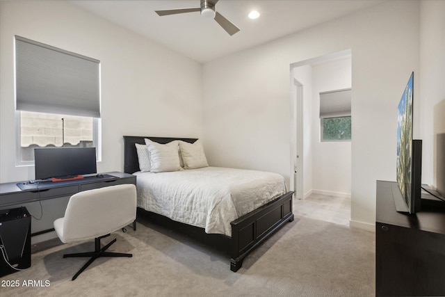 bedroom featuring light carpet, ceiling fan, baseboards, and recessed lighting