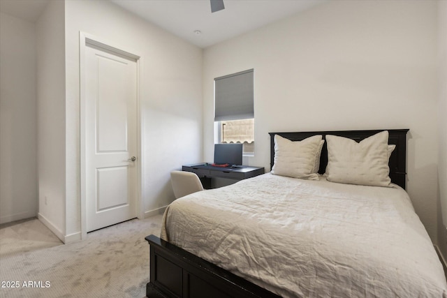 bedroom with ceiling fan, baseboards, and light colored carpet