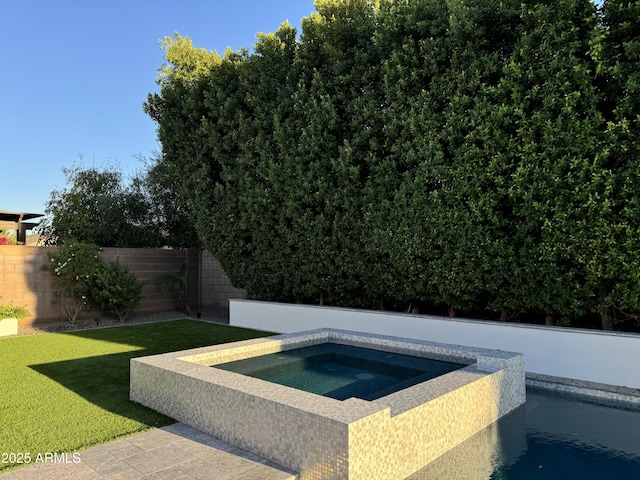 view of pool with a yard, a fenced backyard, and an in ground hot tub