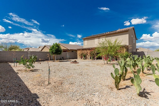 41811 W Avella Dr, Maricopa, AZ 85138 - rear view of house featuring stucco siding, a fenced backyard, and a tiled roof