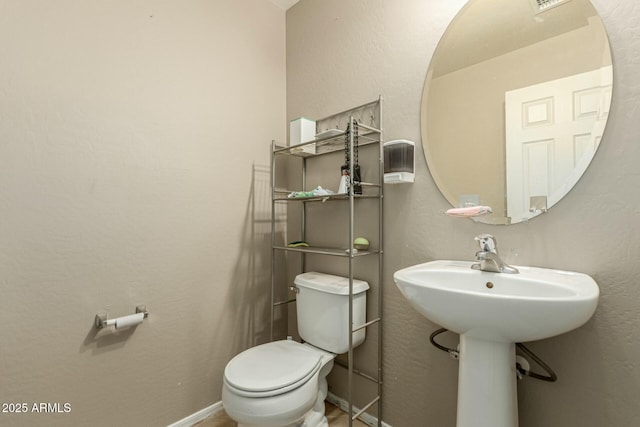 41811 W Avella Dr, Maricopa, AZ 85138 - bathroom with toilet, a sink, a textured wall, and baseboards