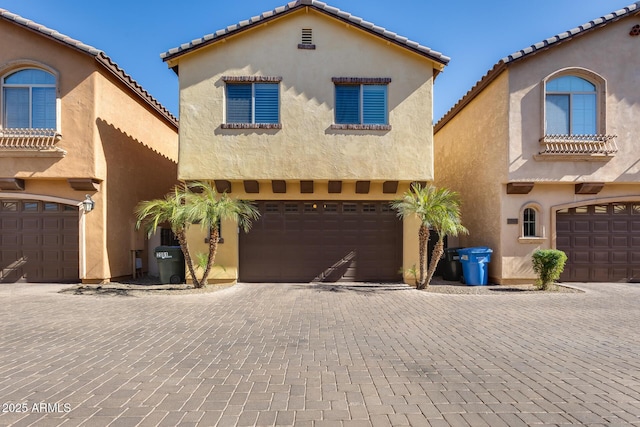 mediterranean / spanish home featuring a garage