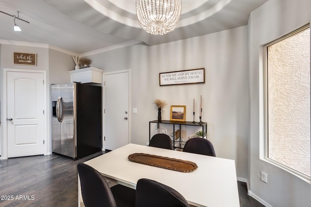 dining area with crown molding, dark hardwood / wood-style floors, and a notable chandelier