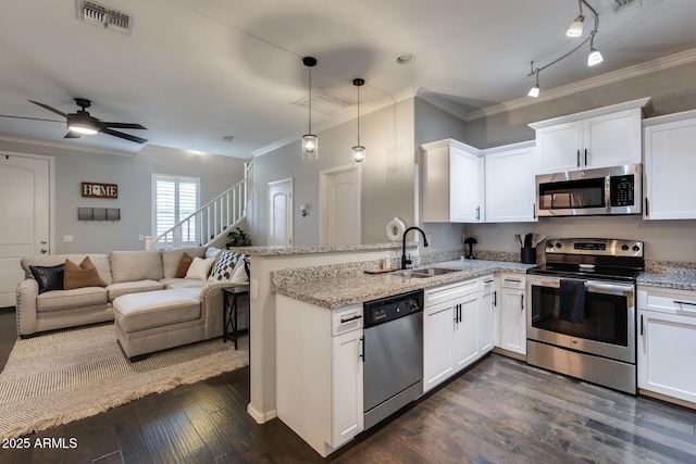 kitchen with white cabinetry, sink, kitchen peninsula, and appliances with stainless steel finishes