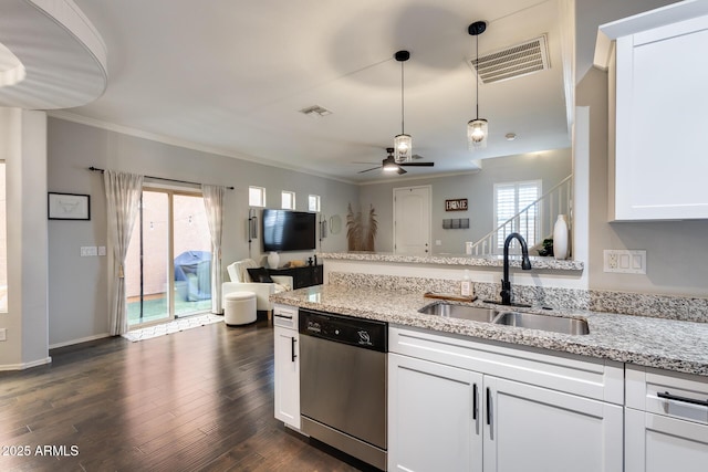 kitchen with light stone counters, sink, stainless steel dishwasher, and white cabinets