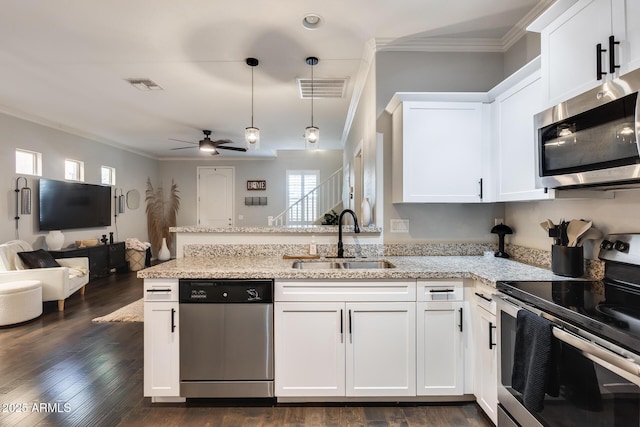 kitchen with white cabinetry, stainless steel appliances, light stone countertops, and sink