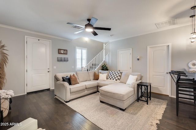 living room with ornamental molding and dark hardwood / wood-style flooring