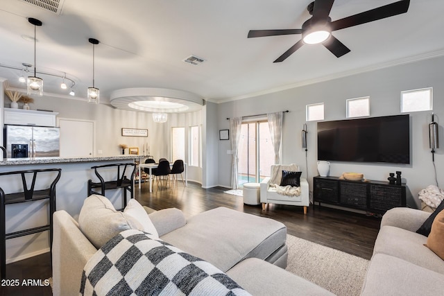 living room featuring crown molding, ceiling fan, and dark hardwood / wood-style floors