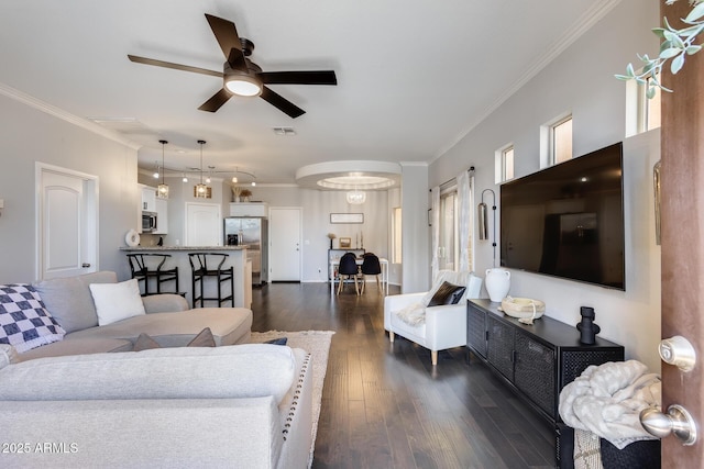 living room featuring crown molding, dark hardwood / wood-style floors, and ceiling fan