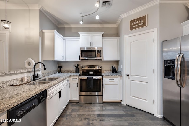 kitchen with decorative light fixtures, white cabinetry, sink, stainless steel appliances, and light stone countertops