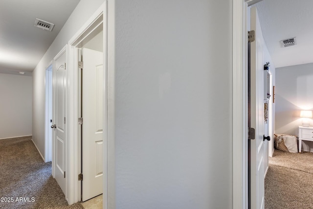 hall featuring light colored carpet