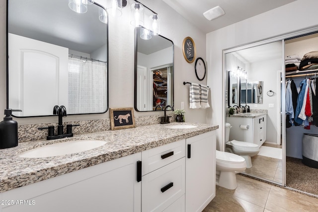 bathroom with vanity, tile patterned floors, and toilet