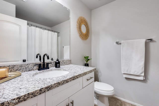 bathroom with tile patterned floors, vanity, and toilet