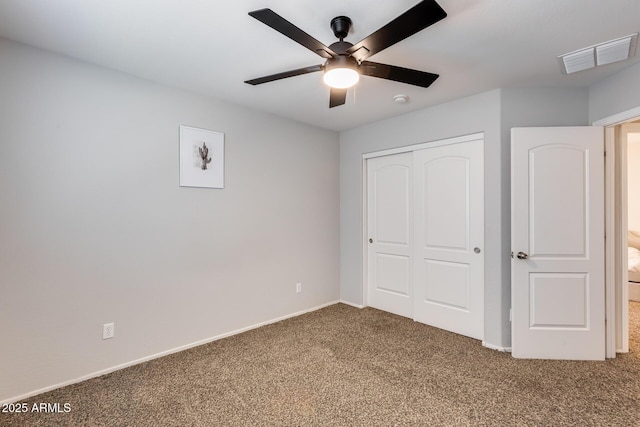 unfurnished bedroom featuring carpet flooring, ceiling fan, and a closet