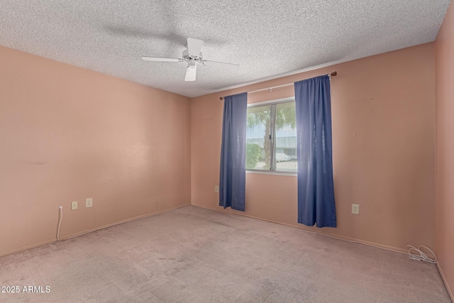 carpeted empty room featuring a textured ceiling and ceiling fan