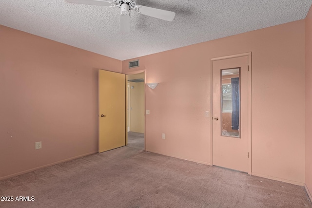 interior space featuring a ceiling fan, visible vents, and a textured ceiling