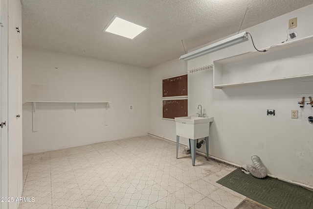 laundry area with light floors, hookup for an electric dryer, laundry area, washer hookup, and a textured ceiling