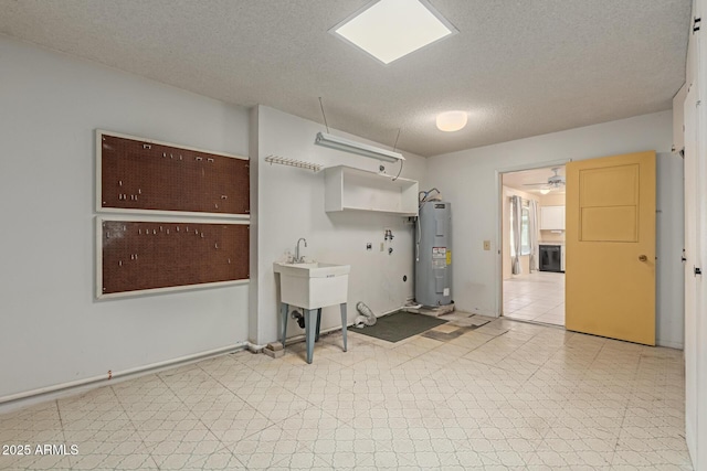 interior space with washer hookup, electric water heater, a textured ceiling, light floors, and laundry area