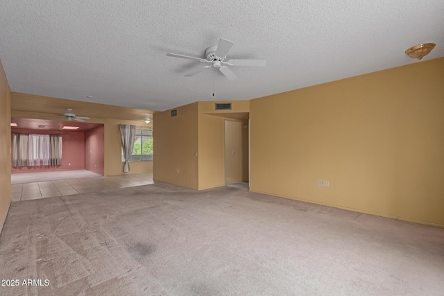 unfurnished living room with visible vents, a textured ceiling, a ceiling fan, and carpet floors