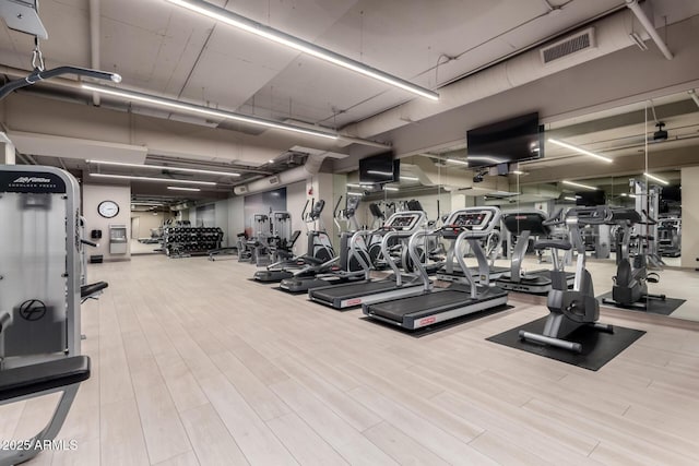 workout area featuring visible vents and wood finished floors