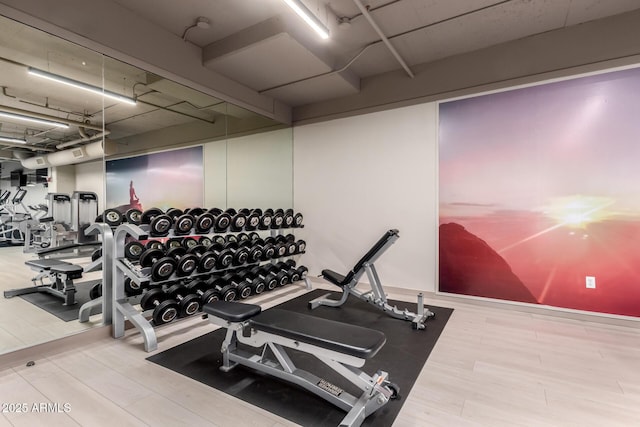 workout area with wood finished floors