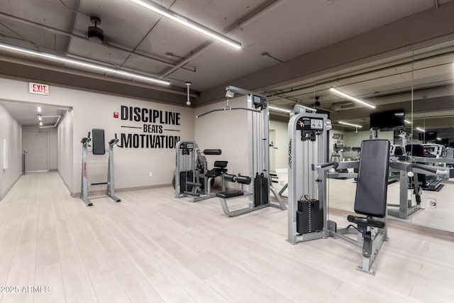 exercise room featuring a garage and wood finished floors