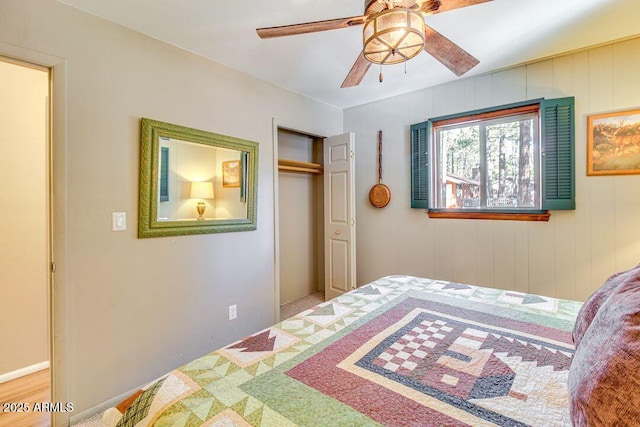 bedroom with ceiling fan and a closet