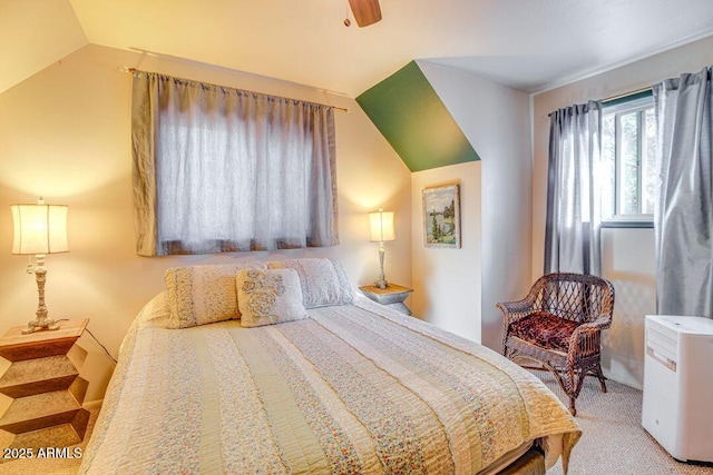 carpeted bedroom featuring ceiling fan and vaulted ceiling