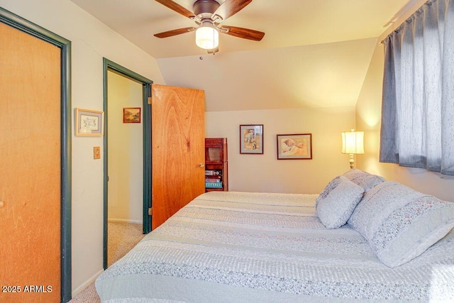 carpeted bedroom featuring lofted ceiling and ceiling fan