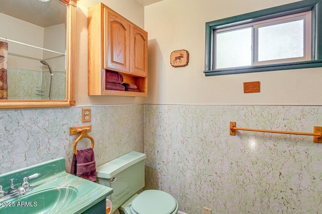 bathroom with toilet, wainscoting, a shower with shower curtain, and vanity