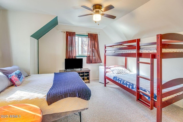 carpeted bedroom featuring a ceiling fan and vaulted ceiling