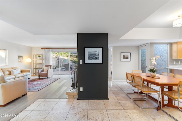 dining space with light tile patterned floors and baseboards