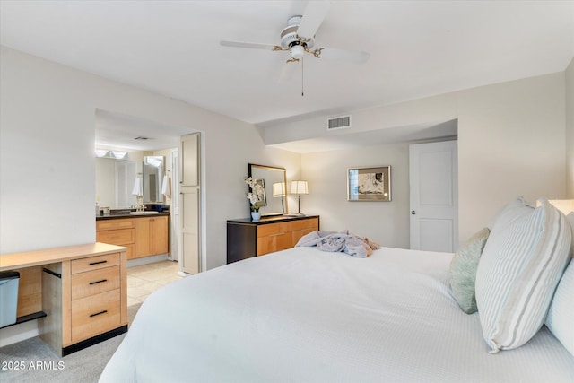 bedroom featuring a ceiling fan, connected bathroom, visible vents, and a sink